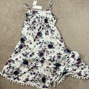 Nwt floral dress. Adjustable straps. Pom Pom detail on bottom
